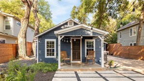 A small house with a porch, two wooden chairs, and a number '100' on the door. - Walkable, Prime E. Austin Location - Casa Cherico (Austin)