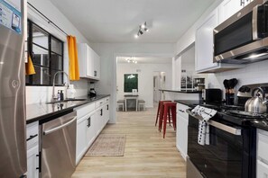 Fridge, microwave, oven, stovetop - 4BR House w/ BBQ grill, Game room & 6 TVs! (Overland Park)