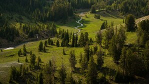 A mountainous landscape with a river flowing through a valley.