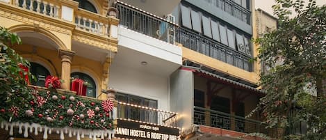 A multi-story building with a hostel and rooftop bar on the ground floor.