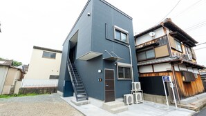 A modern two-story building with a flat roof, a visible staircase, and a satellite dish. - Air Station Front Stay (Izumisano)