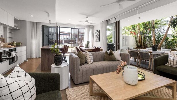 A modern living room with a sofa, coffee table, and dining area. - Aurelia Byron- Jonson Lane (Byron Bay)