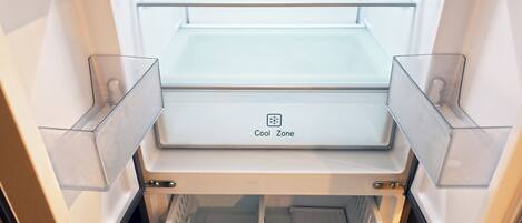 An open refrigerator with multiple shelves and a freezer compartment.