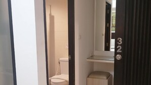 A modern bathroom with a toilet, sink, and a mirror. - AtWhitePatong (Patong)