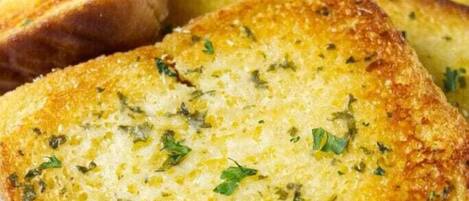 Slices of garlic bread with herbs.