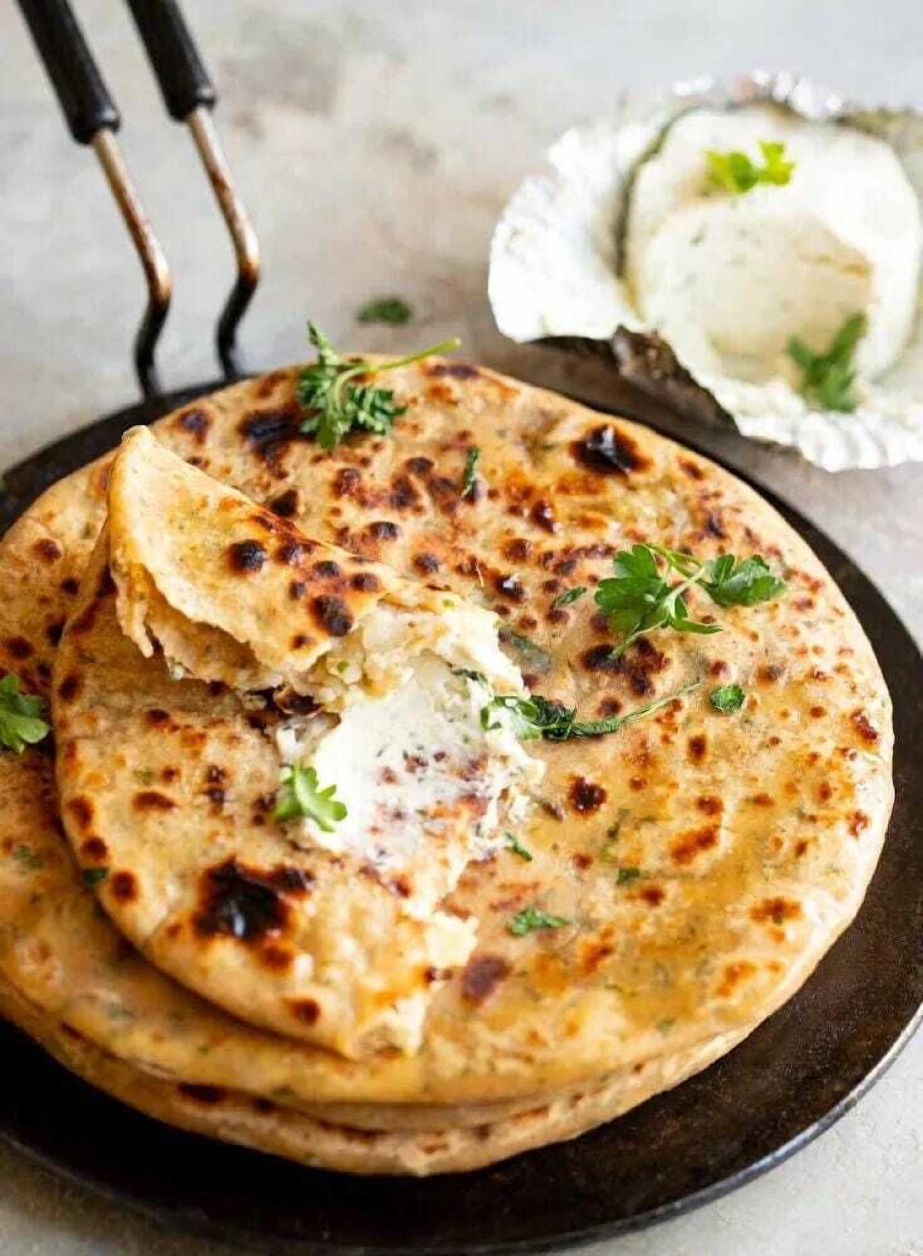 A stack of naan bread on a plate.