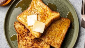A plate of French toast with butter and syrup. - Hotel SS Royal (Amritsar)