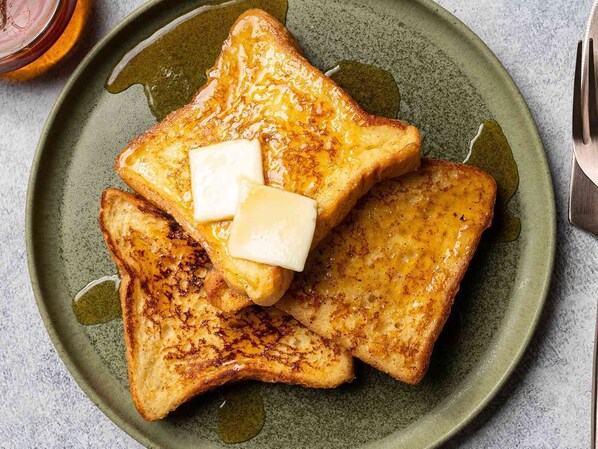 A plate of French toast with butter and syrup. - Hotel SS Royal (Amritsar)