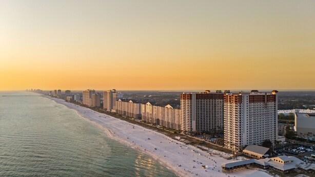 A coastal hotel with multiple high-rise buildings, a beach, and a pier extending into the ocean. - Beachfront Condo, Oceanview Balcony, Lagoon Pool | Thomas Dr #2308 by AvantStay (Panama City)