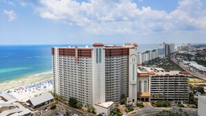 A high-rise hotel with multiple floors, a beach view, and a parking area. - Beachfront Condo, Oceanview Balcony, Lagoon Pool | Thomas Dr #2308 by AvantStay (Panama City)