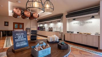 A modern kitchen with a coffee station, a sign indicating 'Guests Only', and a buffet setup.