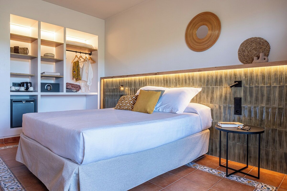Een moderne slaapkamer met een bed, nachtkastje en ingebouwde opbergruimte.