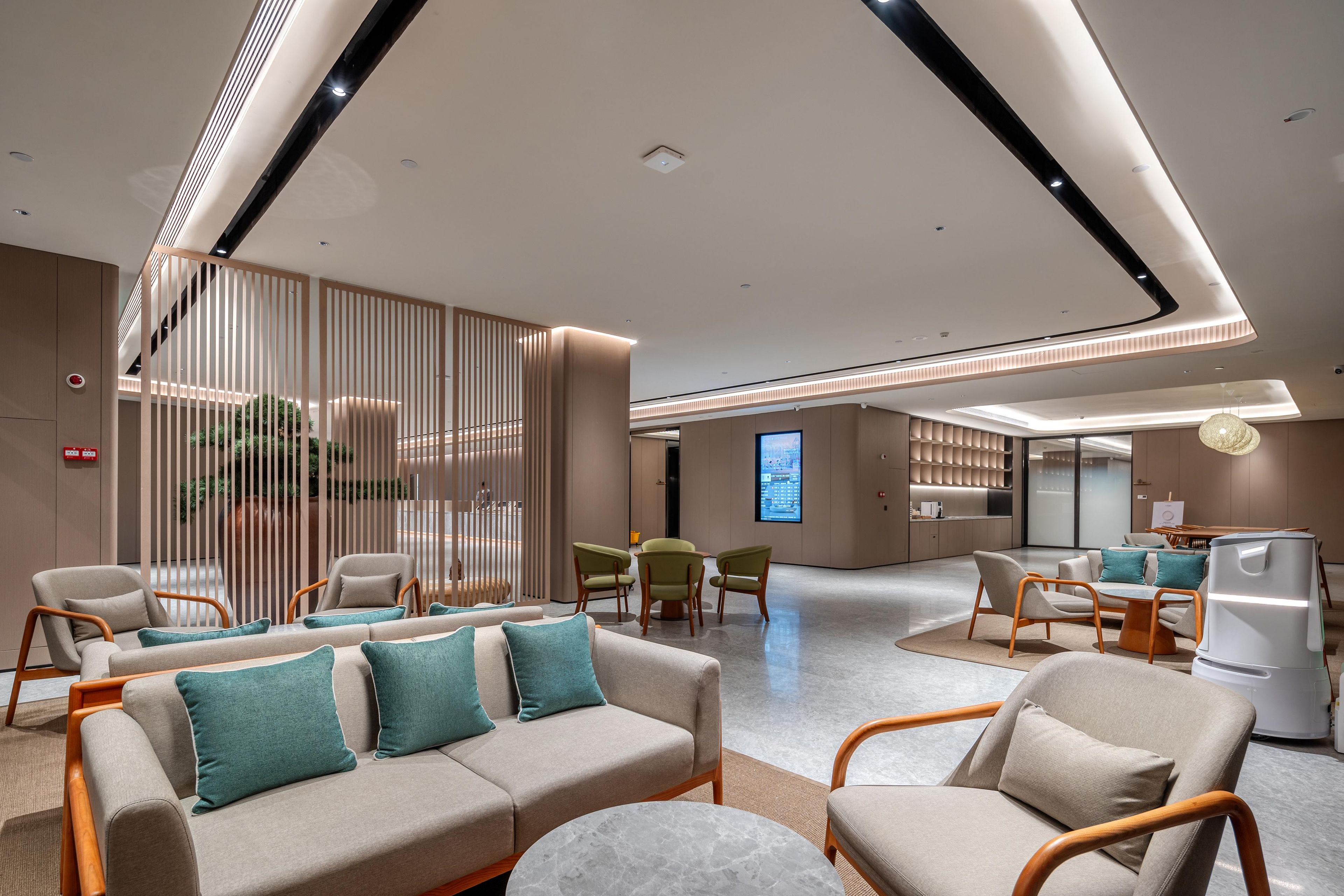A modern interior with a sofa set, chairs, a dining area, and a kitchen.