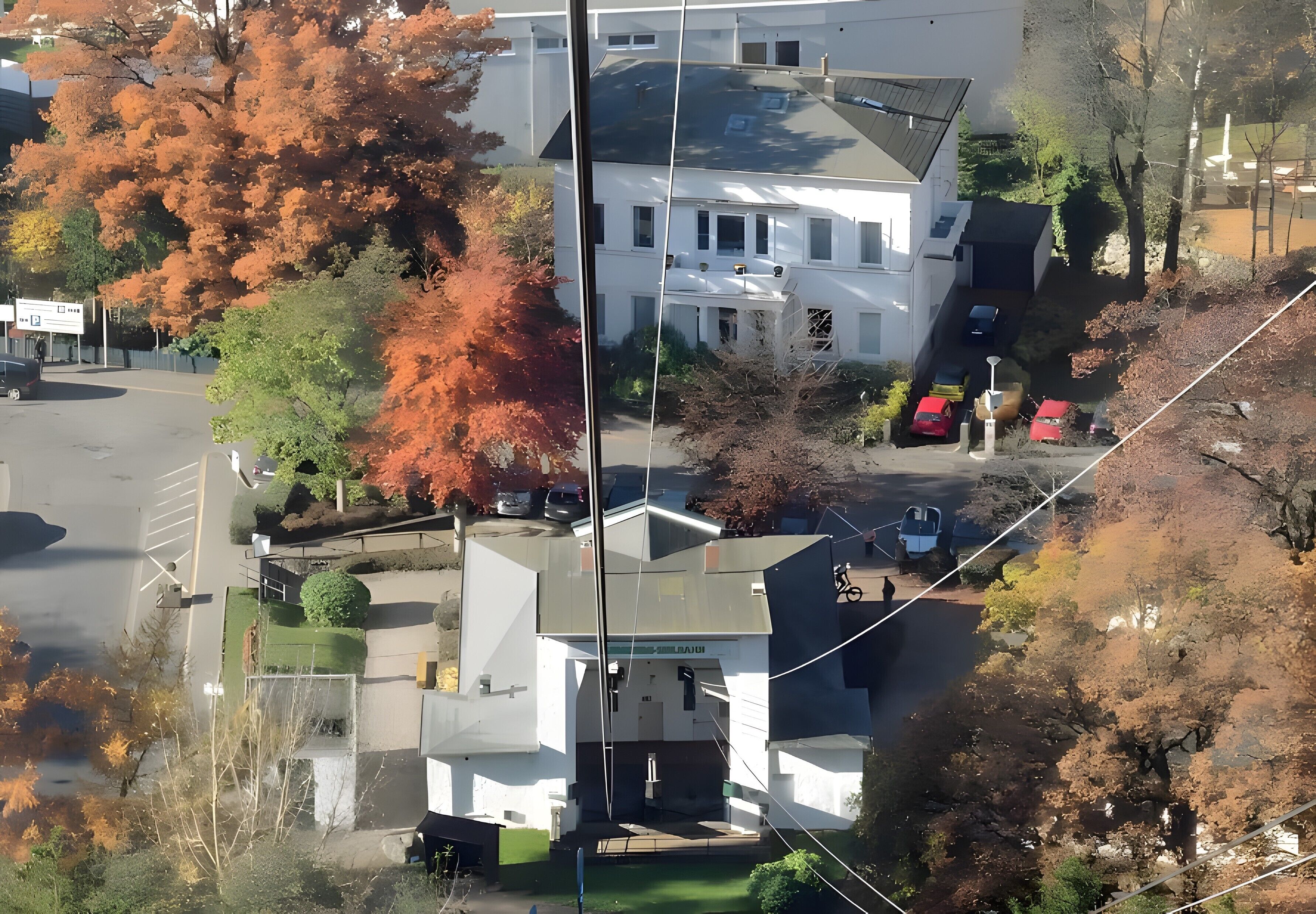 A multi-story building with a central entrance, surrounded by trees with autumn foliage.