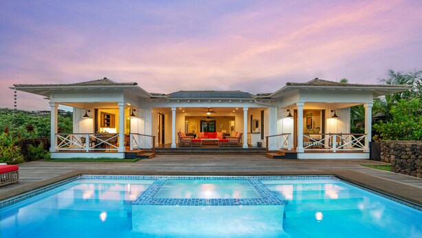 A poolside house with a covered patio, a swimming pool, and a view of the interior.