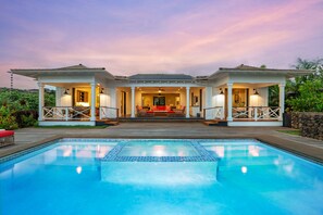 A poolside house with a covered patio, a swimming pool, and a view of the interior. - Hale Hikari by Alekona Kauai: 5BR Ocean View Home w AC, private pool, close to shopping, dining (Koloa)