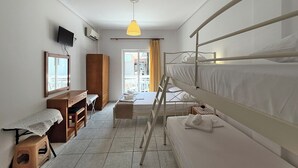 A compact hotel room with bunk beds, a desk, a chair, a wardrobe, and a television. - Meli Studio 304 – Comfort & Functionality for up to 4 Guest (Paralia)