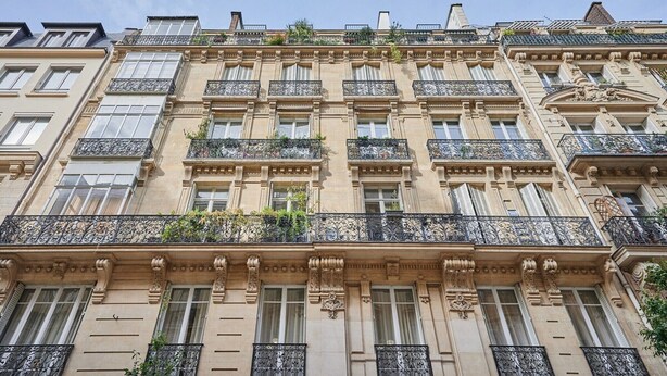 A multi-story building with ornate architectural details, including decorative moldings and wrought iron balconies. - Sublime apartment in the center of Paris (Paris)