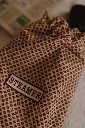 A fabric with a pattern and a tag labeled "STEAMER".