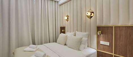 Desk, iron/ironing board, bed sheets