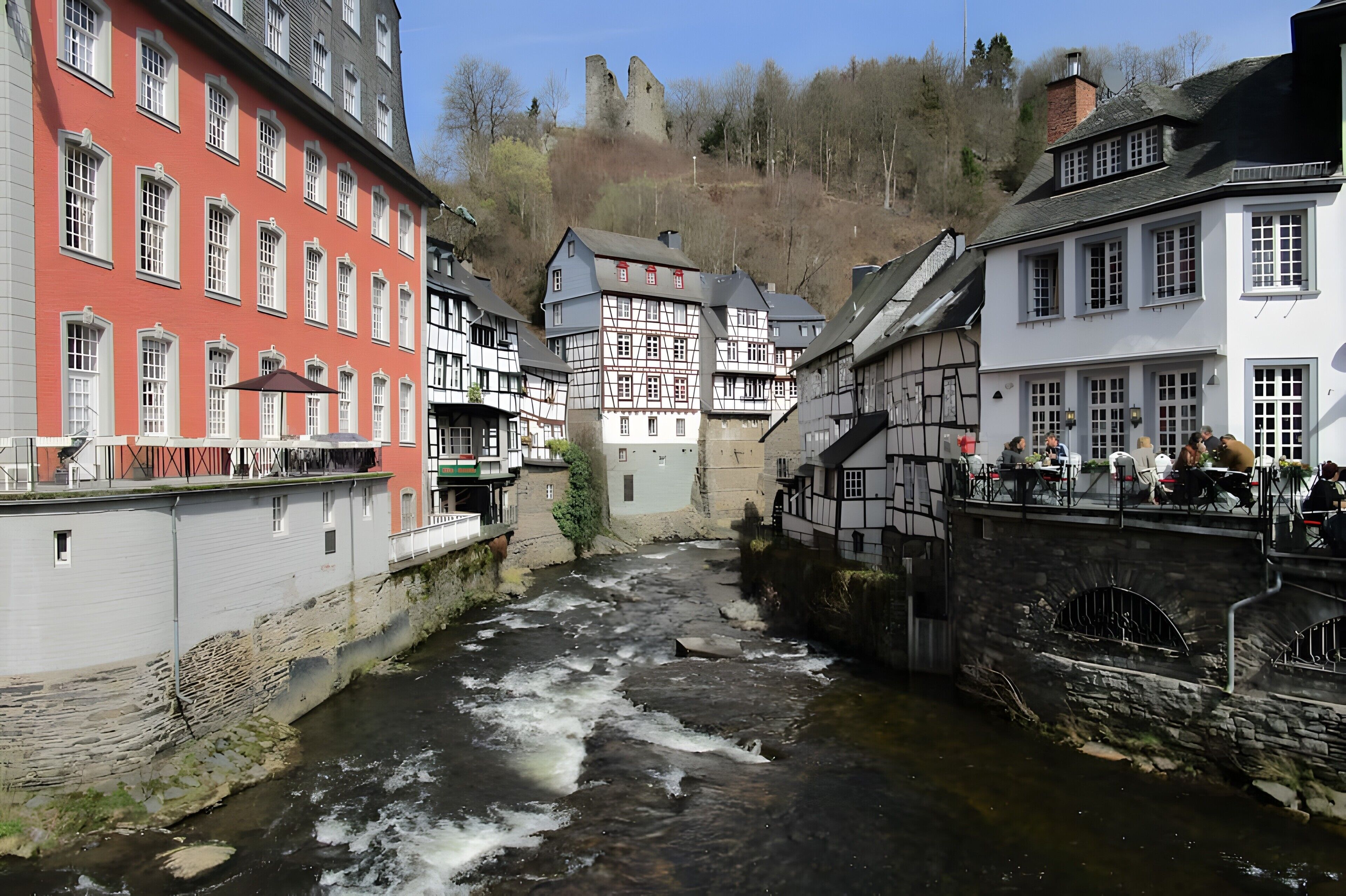 A river running through a town with historic buildings on either side.