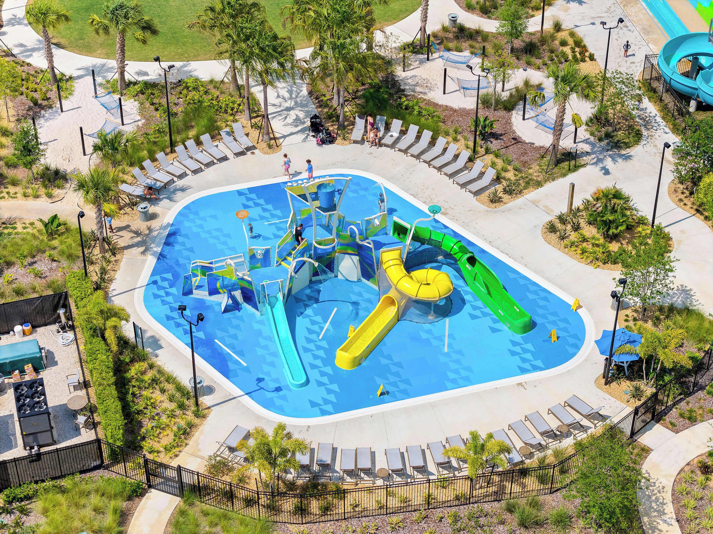 Ein Wasserpark mit Pool, Rutschen und Liegebereichen.