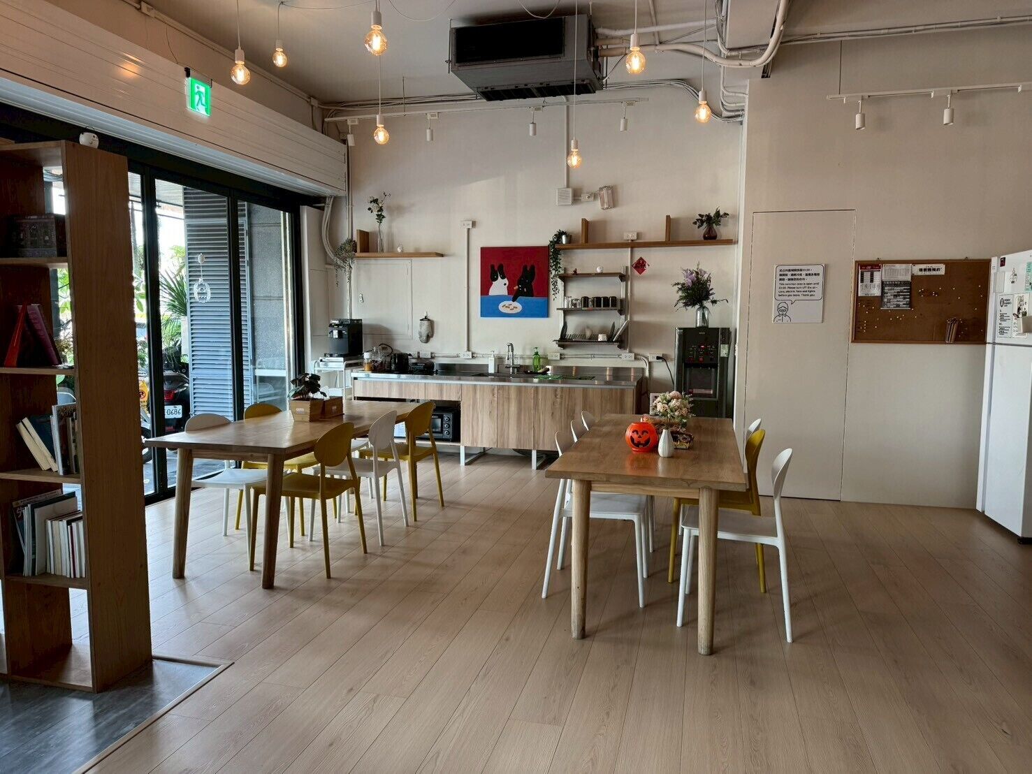 A modern kitchen with a central island, wooden chairs, and a dining table.