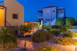 Ein modernes, zweistöckiges Gebäude mit Balkon und überdachter Terrasse.