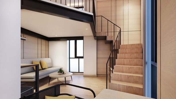 A modern living room with a sofa, coffee table, and a staircase. - Beezie Hotel (Palembang)