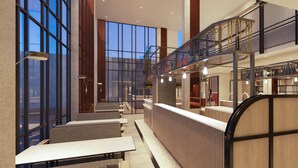A modern interior with a bar area, seating, and a staircase. - Beezie Hotel (Palembang)