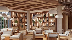A modern lounge area with wooden furniture, pendant lighting, and a variety of decorative items on shelves. - Elba Corralejo Premium Level Only Adults (Corralejo)