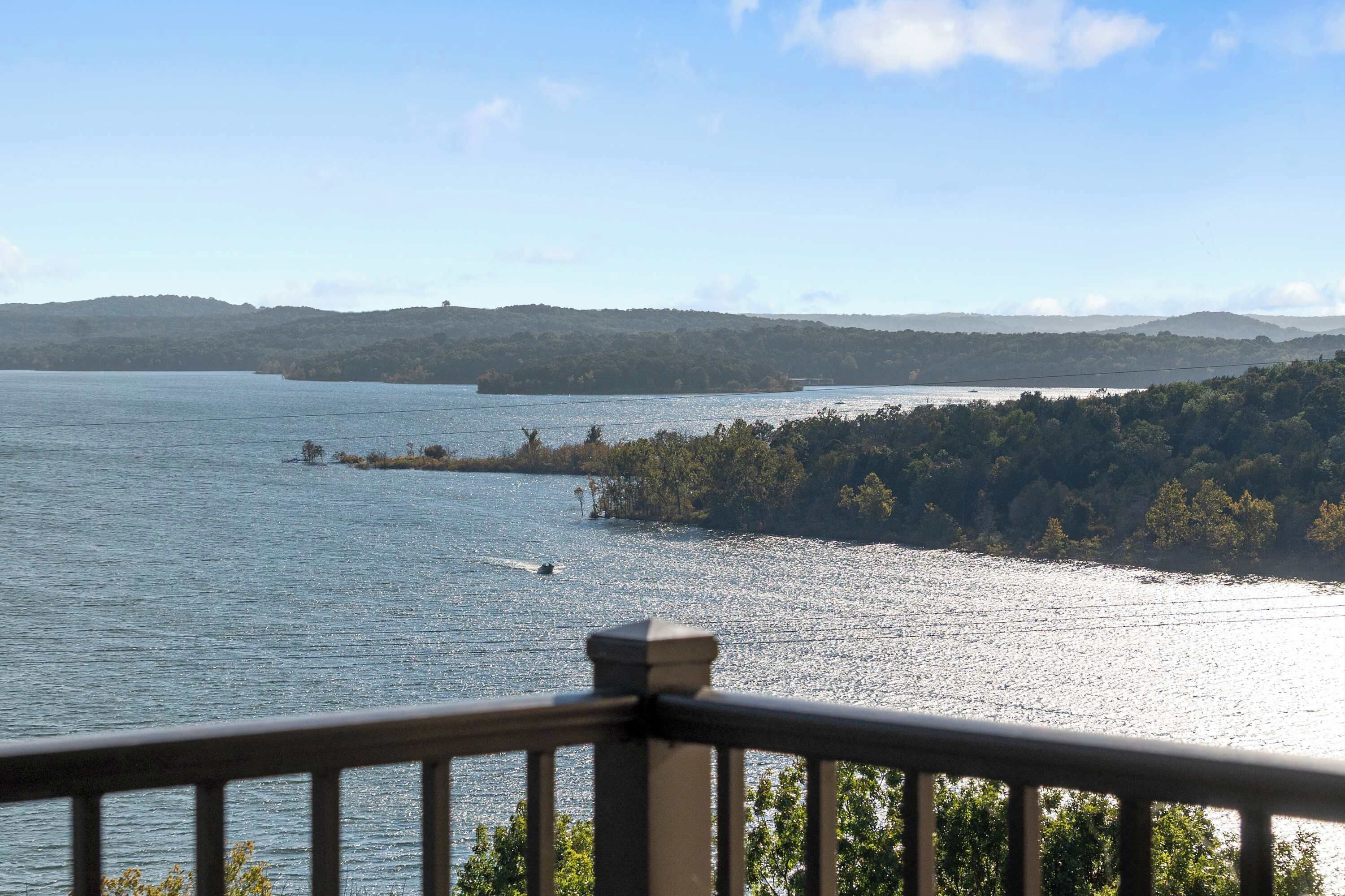 A view of a lake with a distant island and hills.