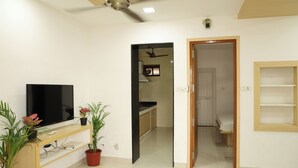 Deluxe Villa | Living area | 43-inch LED TV with satellite channels - Aaru Residency (Coimbatore)