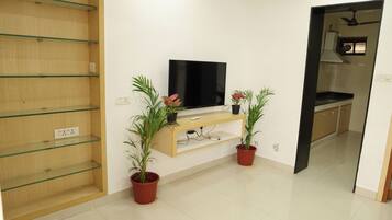 Deluxe Villa | Living area | 43-inch LED TV with satellite channels