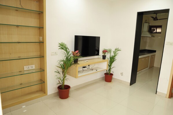 Deluxe Villa | Living area | 43-inch LED TV with satellite channels