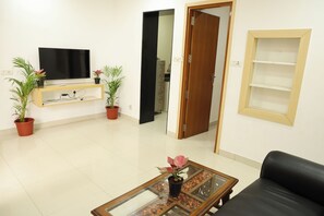 Deluxe Villa | Living area | 43-inch LED TV with satellite channels - Aaru Residency (Coimbatore)