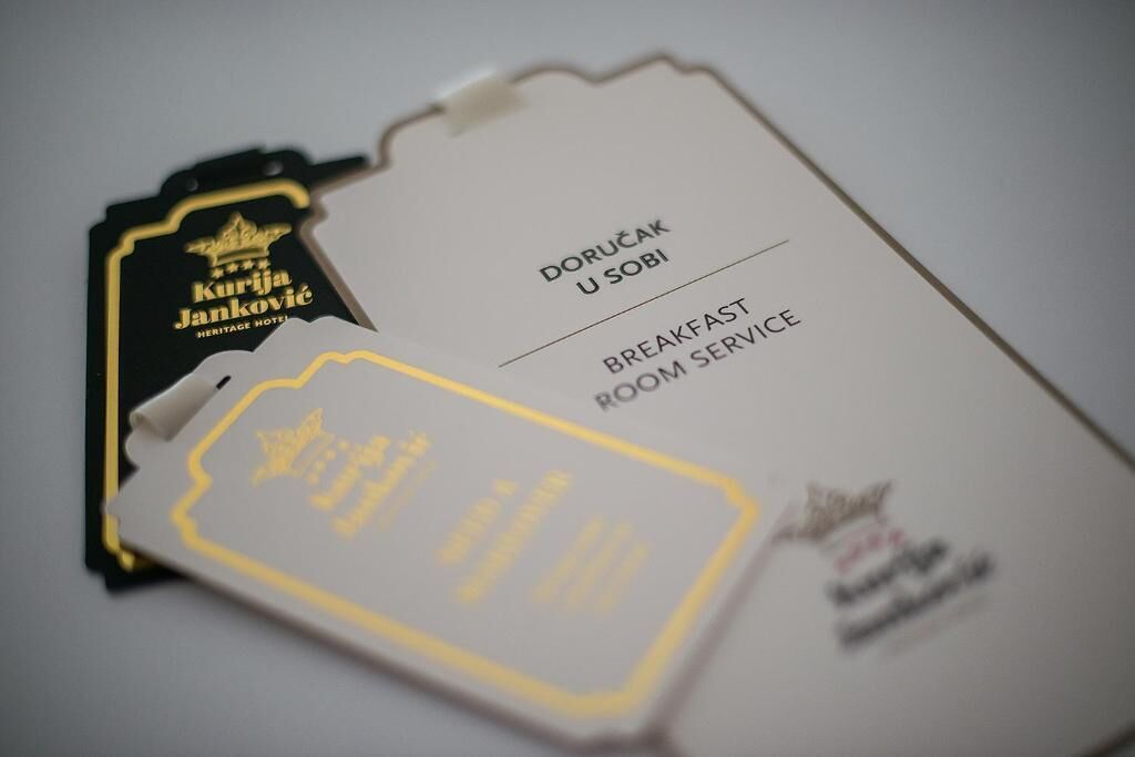 A hotel room service card with the text "DORUČAK U SOBI BREAKFAST ROOM SERVICE".