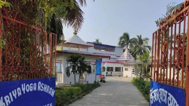A gated entrance to a building with a sign reading "KRIYA YOGA ASHRAM GANGASAGAR MATH". - Kriya Yoga Wellness (Kakdwip)