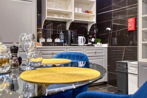 Eine moderne Küche mit Kaffeemaschine, Tee-Station und einem roten Brandschutznachweis.