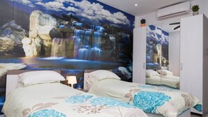 A bedroom with two beds, a large mural of a waterfall, a wardrobe, and an air conditioning unit. - Azure Apartment (Senglea)