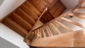A spiral staircase with wooden steps and handrails. - Hidden Secret of Nature in the middle of Old Flanders, in nature. (Maaseik)