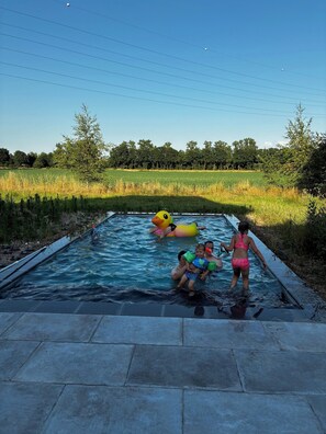 A swimming pool with people and inflatable toys. - Hidden Secret of Nature in the middle of Old Flanders, in nature. (Maaseik)
