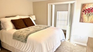 A bedroom with a large bed, a nightstand, a lamp, and a painting on the wall. - “Just Lake Home” Wonderful 3bdrm 2bath lake front,boat ramp, dock, pet friendly (Jackson's Gap)