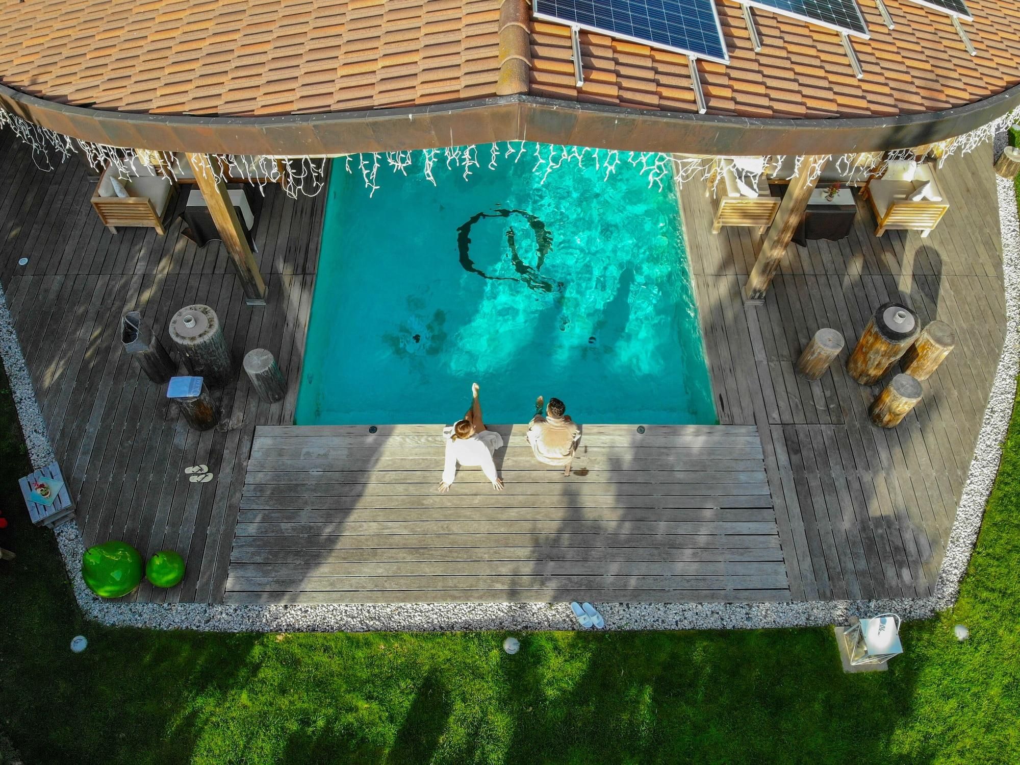 A rooftop pool with two people relaxing.