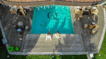 A rooftop pool with two people relaxing.