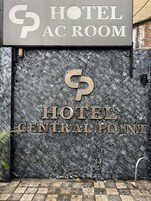 A hotel entrance with a sign reading "HOTEL AC ROOM" and "HOTEL CENTRAL POINT".