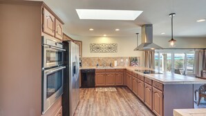 A modern kitchen with built-in appliances, a large island, and a skylight. - Enjoy Million-dollar Views! Lake Havasu City Home (Lake Havasu City)