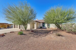 A house with a gravel driveway, two large trees, and a clear blue sky. - Enjoy Million-dollar Views! Lake Havasu City Home (Lake Havasu City)