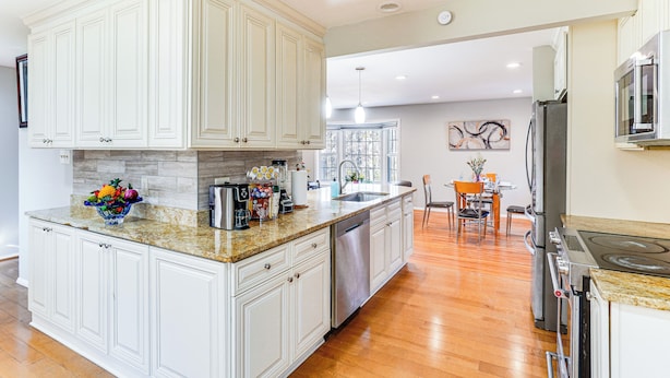 A spacious kitchen with white cabinetry, a granite countertop, and stainless steel appliances. - 5 Mi to Lake Accotink Park: Modern Home w/ Yard (Springfield)