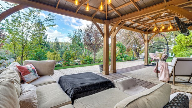 An outdoor patio with a wooden pergola, cushioned seating, and hanging lights. - Work & Relax! Updated Walnut Creek Home w/ Office (Walnut Creek)